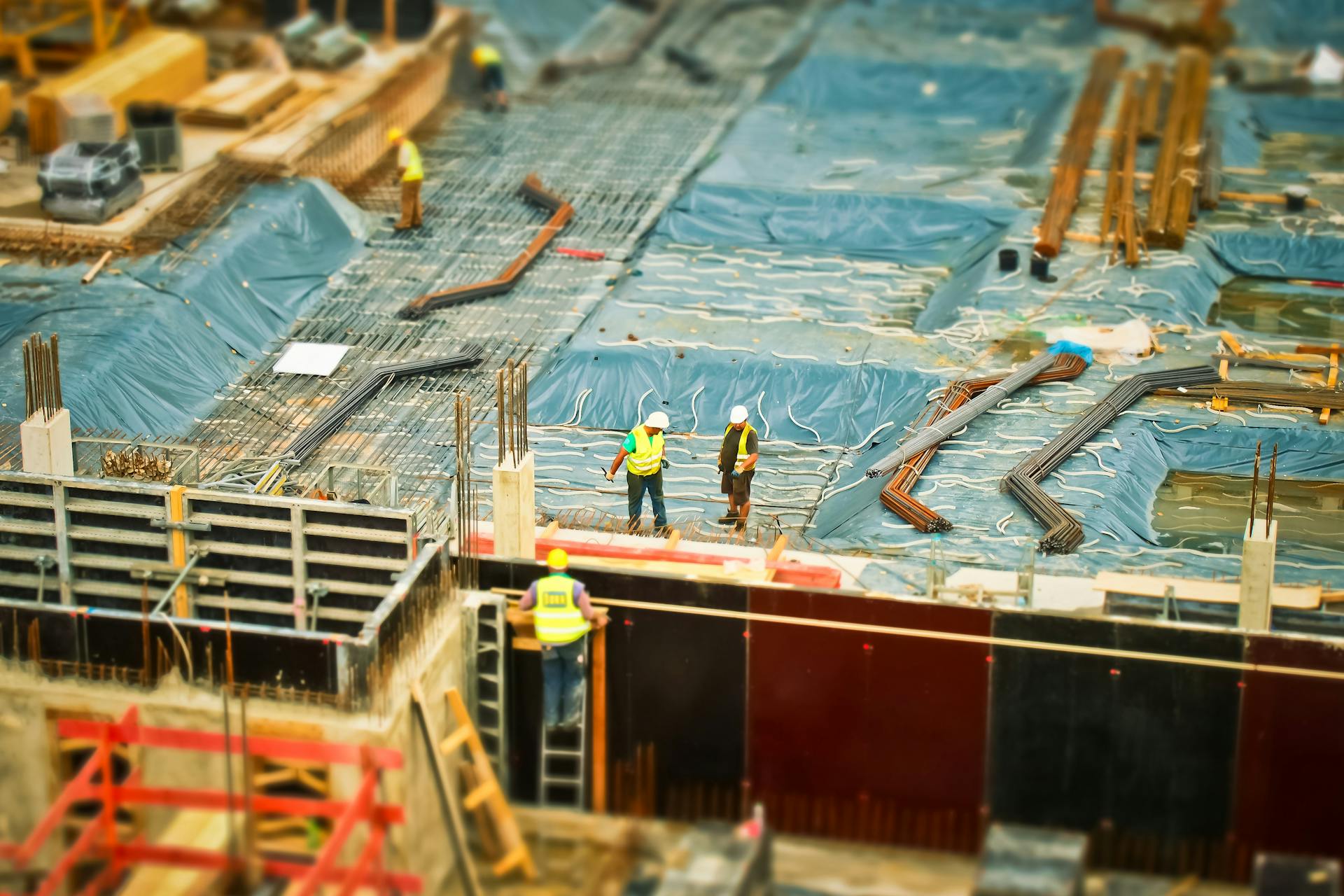 Active construction site with cranes and steel framework